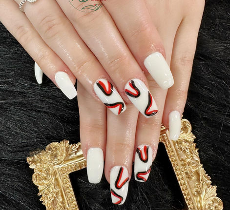 White nails with flowing red and black line art