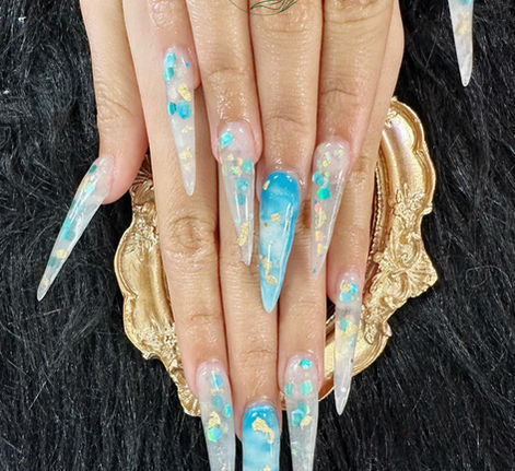 Long blue stiletto nails with gold foil and confetti details