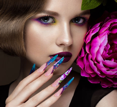 Editorial beauty look featuring colourful stiletto nail art
