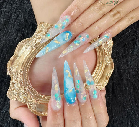 Long blue translucent stiletto nails with gold foil