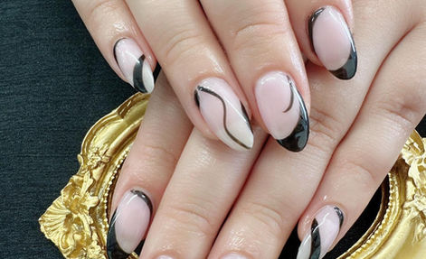 Blush nails with flowing black and white French-tip designs