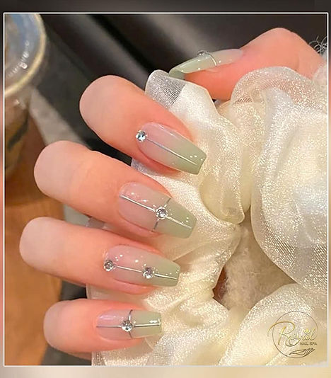 Sage green coffin nails with silver line and crystal accents