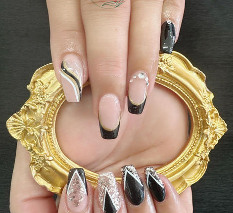 Black and nude manicure with silver glitter accents
